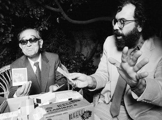 Francis Ford Coppola shows Akira Kurosawa his new polaroid Francis Ford Coppola shows Akira Kurosawa his new polaroid