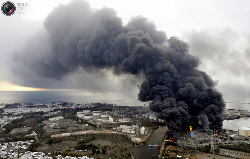Дым над горящей фабрикой, Сендай, префектура Мияги, 12 марта 2011 
года.