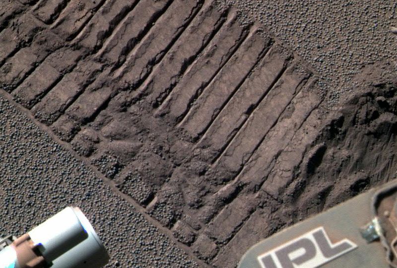 Марсоход «Opportunity» направил свою панорамную камеру на почву, захватив в кадр себя и свои следы, 23 июня. (NASA/JPL)