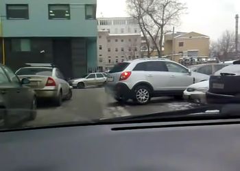 Девушка пытается выехать с парковки